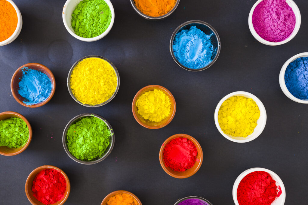 various holi color powder bowl black background